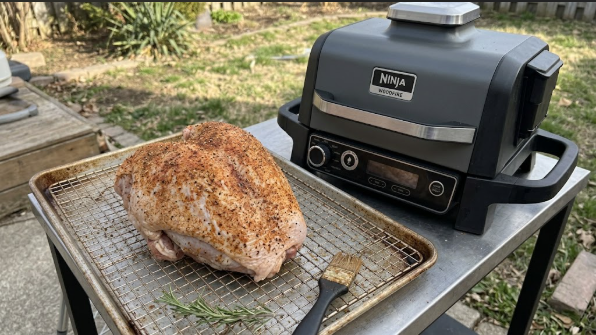 Bone-in turkey breast seasoned and sitting on a wire rack before going on the Ninja Woodfire Grill