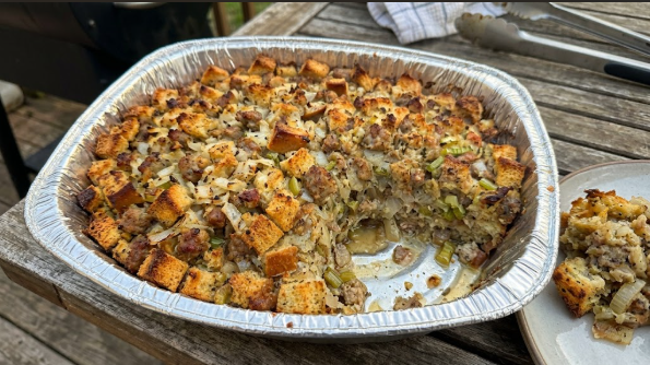 Finished stuffing in the pan with a golden crisp top, one scoop removed to show the moist center