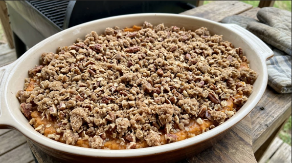 Casserole pan with pecan streusel spread evenly before going on the grill