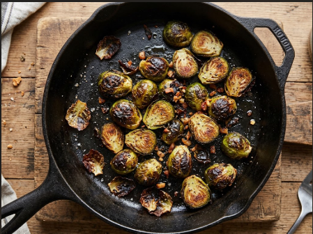  Finished skillet of cast iron Brussels sprouts with dark, crispy edges, shot from above