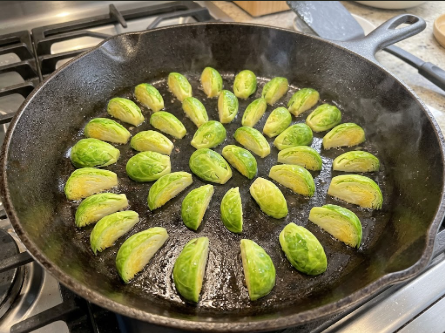 Sprouts arranged cut-side down in the hot skillet, showing the single-layer spacing
