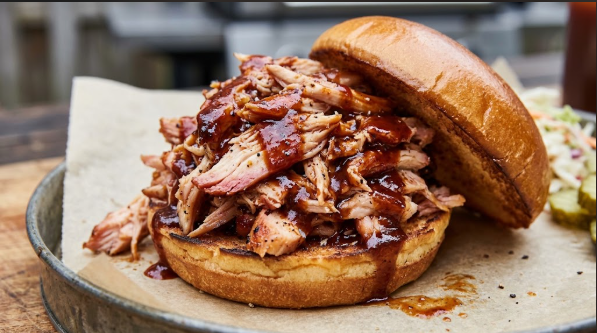 Shredded smoked chicken breast tossed in BBQ sauce, piled on a bun