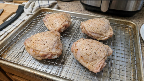 Dry-brined thighs on a wire rack, patted dry and lightly seasoned