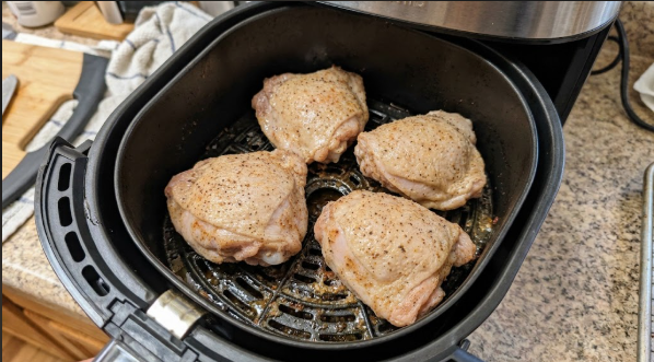  Thighs flipped skin-side up halfway through cooking, with rendered fat in the drawer