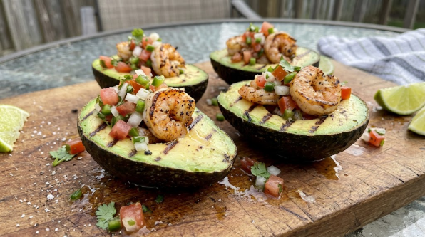 Finished grilled avocado halves filled with shrimp and pico de gallo