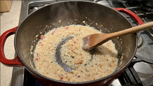 Roux turning from pale paste to wet-sand texture just before the broth goes in
