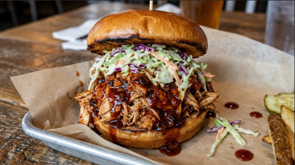  Piled-high BBQ chicken sandwich on a toasted bun with coleslaw
