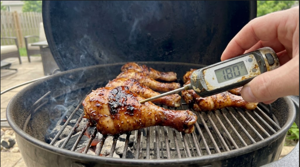 Instant-read thermometer reading 180°F in a glazed drumstick